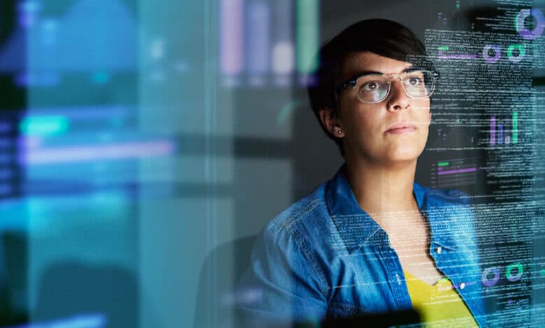 young computer programmer looking through data