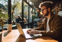 Person using a laptop on public Wi-Fi in a café environment