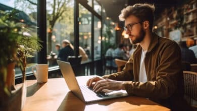 Person using a laptop on public Wi-Fi in a café environment